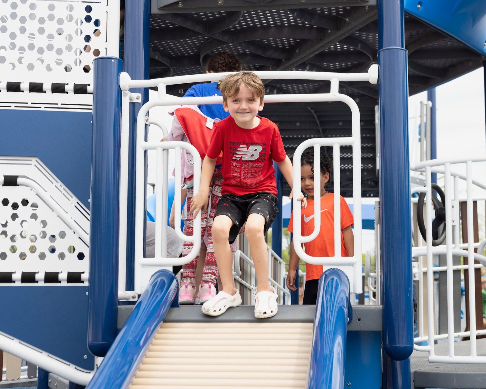 Children playing on a finished Pro Play playground after close-out and handoff